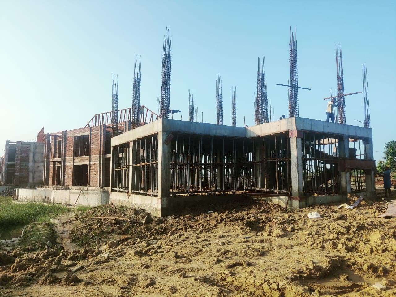 Concrete building frame under construction with exposed column reinforcement